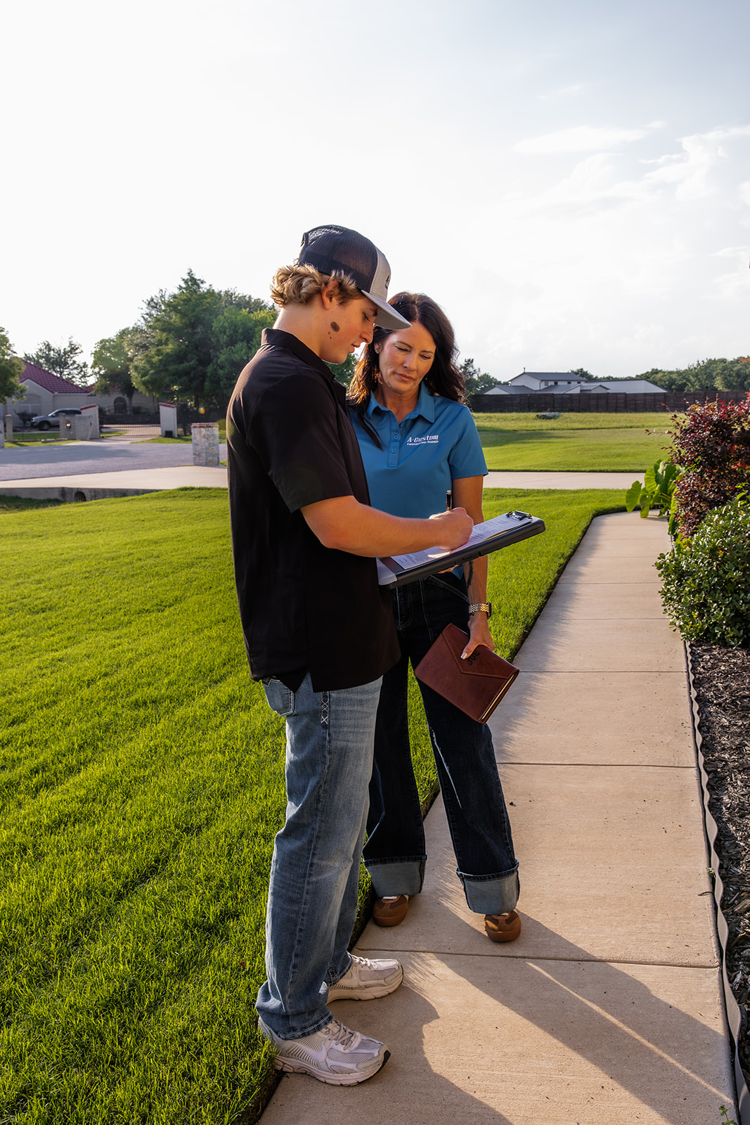 person signing clipboard outdoors
