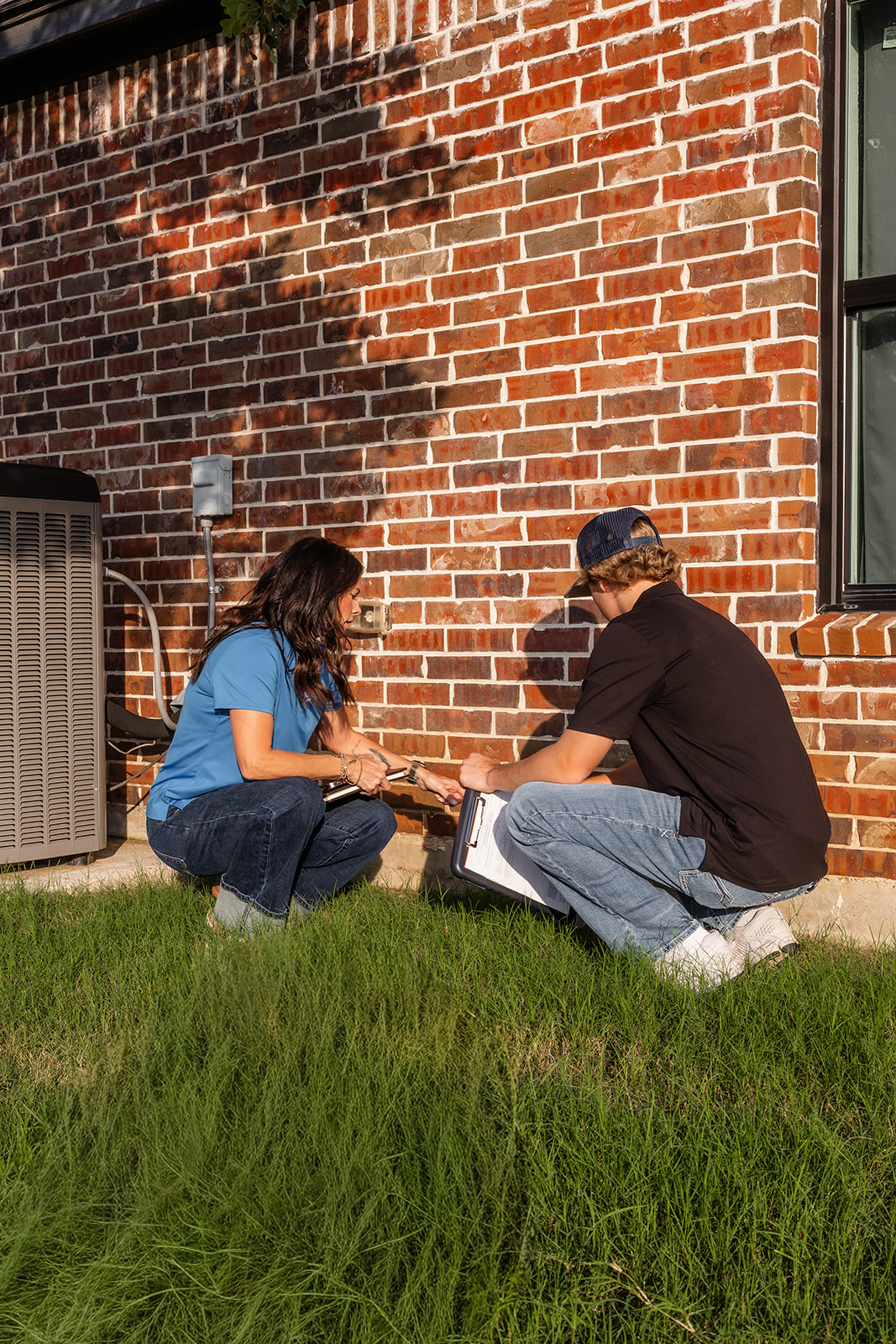 two people inspecting wall