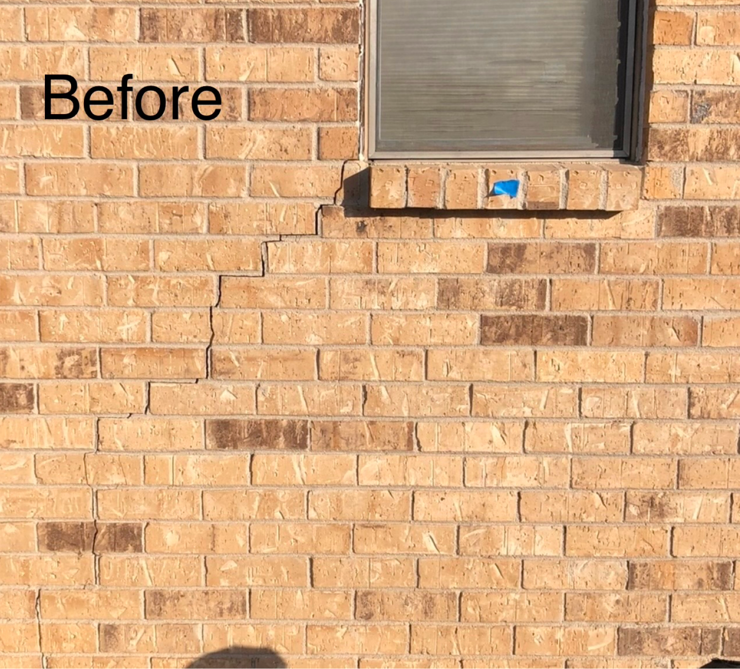 Stair-step crack at a window, before